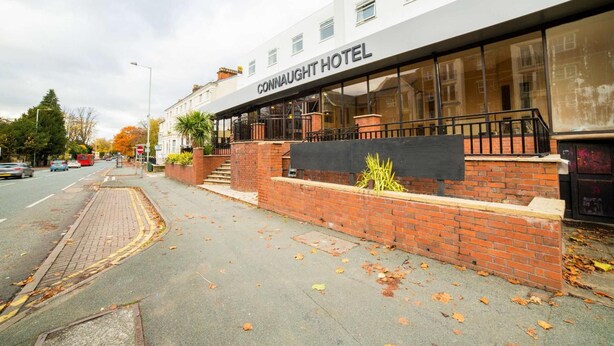 A hotel with a modern facade, a visible entrance, and a brick wall with plants. - Best Western the Connaught Hotel (Wolverhampton)