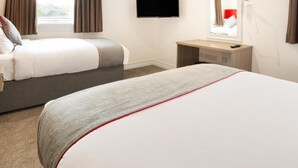 A hotel room with two beds, a TV, a desk, and a window with curtains. - Best Western the Connaught Hotel (Wolverhampton)
