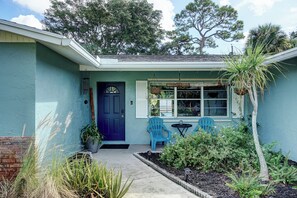 A house with a blue door, two blue Adirondack chairs, and a small garden. - Dog-Friendly home with quick access to the beach and downtown with heated pool. (Stuart)