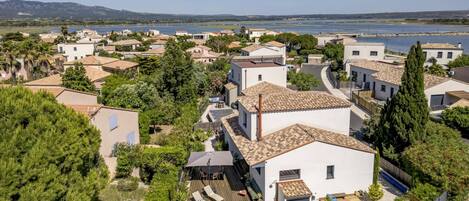 A residential area with houses, a swimming pool, and a view of the water body.