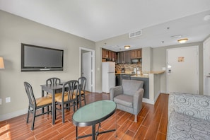 A compact living space with a dining area, kitchenette, and seating area. - Scenic Lakeview Condo w Balcony and Resort Pools (Orlando)