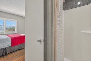 A room with a bed, a window, and a door. - Scenic Lakeview Condo w Balcony and Resort Pools (Orlando)