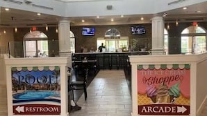 A mall interior with a pool, restrooms, and an arcade. - The Ultimate Escape at Regal Palms w/ Pool & Lazy River (Davenport)
