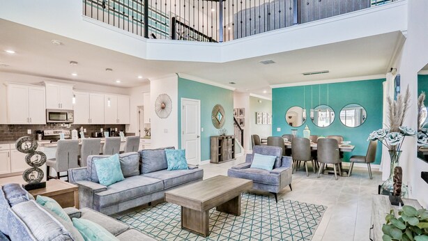 A spacious living area with a dining table, sofas, and a kitchen in the background. - All-new, Charming Home With Screened Pool With Spa, Game Room, & Foosball (Davenport)