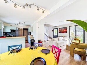 A modern interior with a dining area, kitchen, and living space. - Maison de Suffren by Interhome (St Gildas-de-Rhuys)