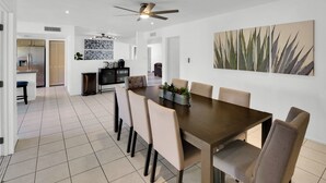 A modern dining area with a large table, chairs, and a ceiling fan. - Scottsdale Oasis Diving Pool, Game Room & 4BR Near Old Town & Mayo Clinic (Scottsdale)