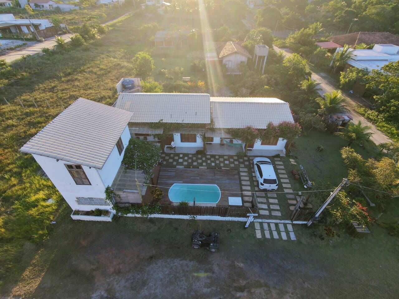 A house with a swimming pool, a carport, and a fenced yard.