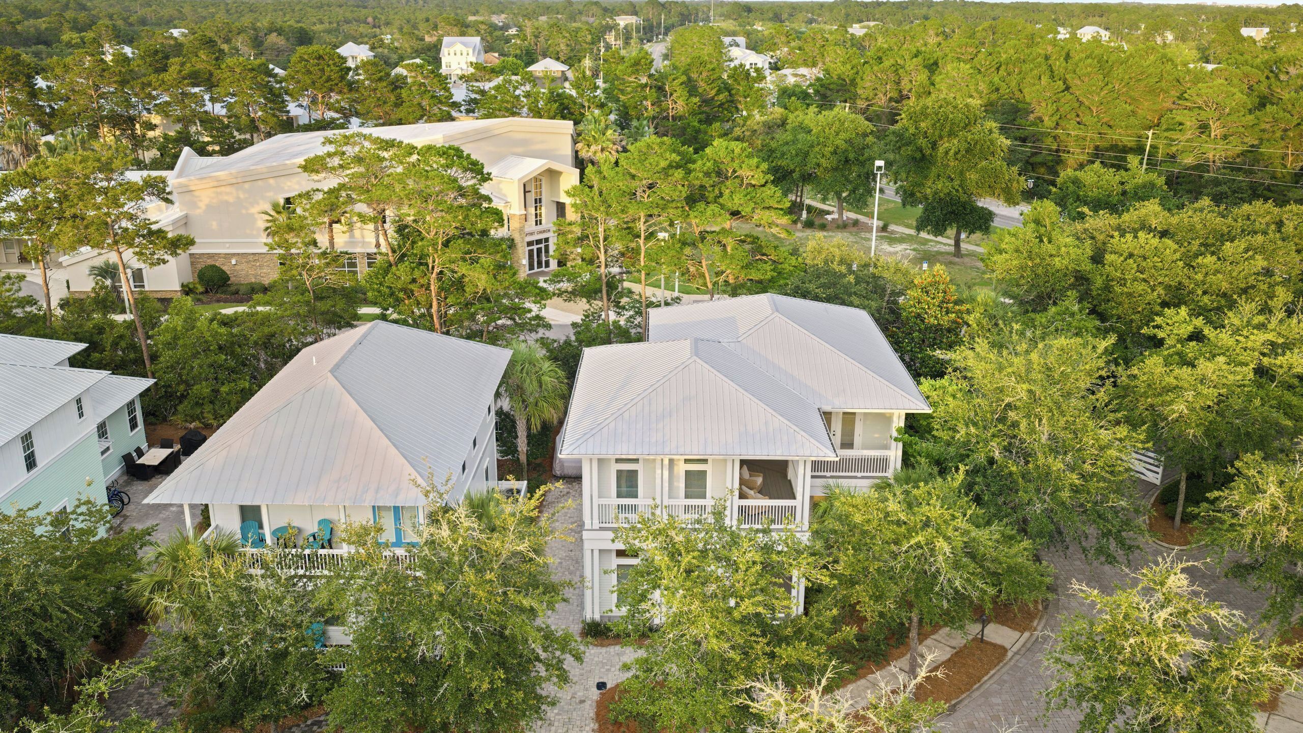 A residential area with houses surrounded by trees.
