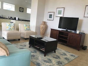 A living room with a sofa, armchairs, a coffee table, a TV, and a cabinet. - Restored 17th Century Boiling House with Beach Club membership (St. James)