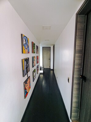 A hallway with a black floor, white walls, and a door at the end. - Beautiful and Spacious Apartment in Chapinero Bogota DC (Bogotá, D.C.)