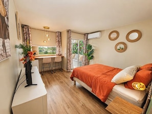 A room with a bed, desk, chairs, and a window with curtains. - Tropical Chic Studio with Views of the Marina and Pool - Le Carayou Residence🌴 (Les Trois-Îlets)
