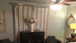 A bedroom with a bed, two armchairs, a dresser, a ceiling fan, and a lamp. - FULLY FURNISHED 4 bed 3 bath, bills paid, internet, washer/dryer, maid service (Vernon)