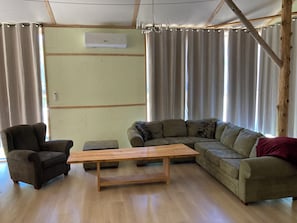 A living room with a sofa, armchair, and wooden coffee table.