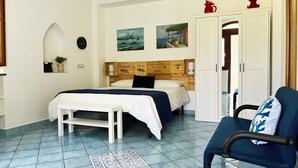 A bedroom with a bed, bedside table, chair, and a wardrobe. - Casa Tasca, a cozy and quiet apartment with a large terrace. (Ravello)