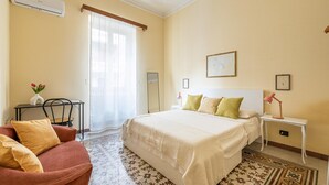 A hotel room with a bed, a desk, a chair, and a window with curtains. - Zisa Gardens of Palermo (PALERMO)