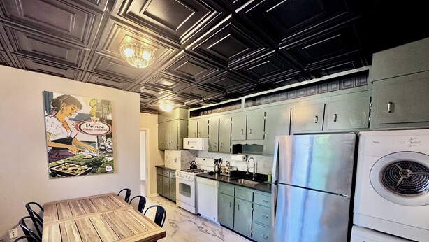 A modern kitchen with a wooden dining table, stainless steel appliances, and a marble floor. - Family-friendly 4-bedroom apartment in the historic North End of Boston (Boston)