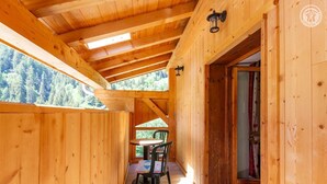 A wooden cabin with a dining area, a table, and chairs. - L'Eau de Mai - PLANAY (PLANAY)