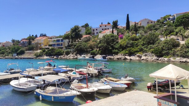 A marina with various boats docked, surrounded by buildings and greenery. - 2 bedroom gorgeous apartment in Okrug Gornji (Okrug Gornji)