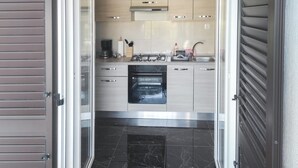 A modern kitchen with a built-in oven, a coffee maker, and a gas stove. - 2 bedroom gorgeous apartment in Okrug Gornji (Okrug Gornji)