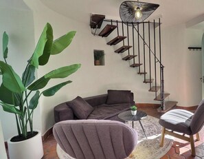 A staircase with a modern design, a ceiling fan, and a view of the outdoors.