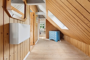 A narrow hallway with wooden walls and a sloped ceiling. - Charming 45 m² house in peaceful setting (Gelsted)