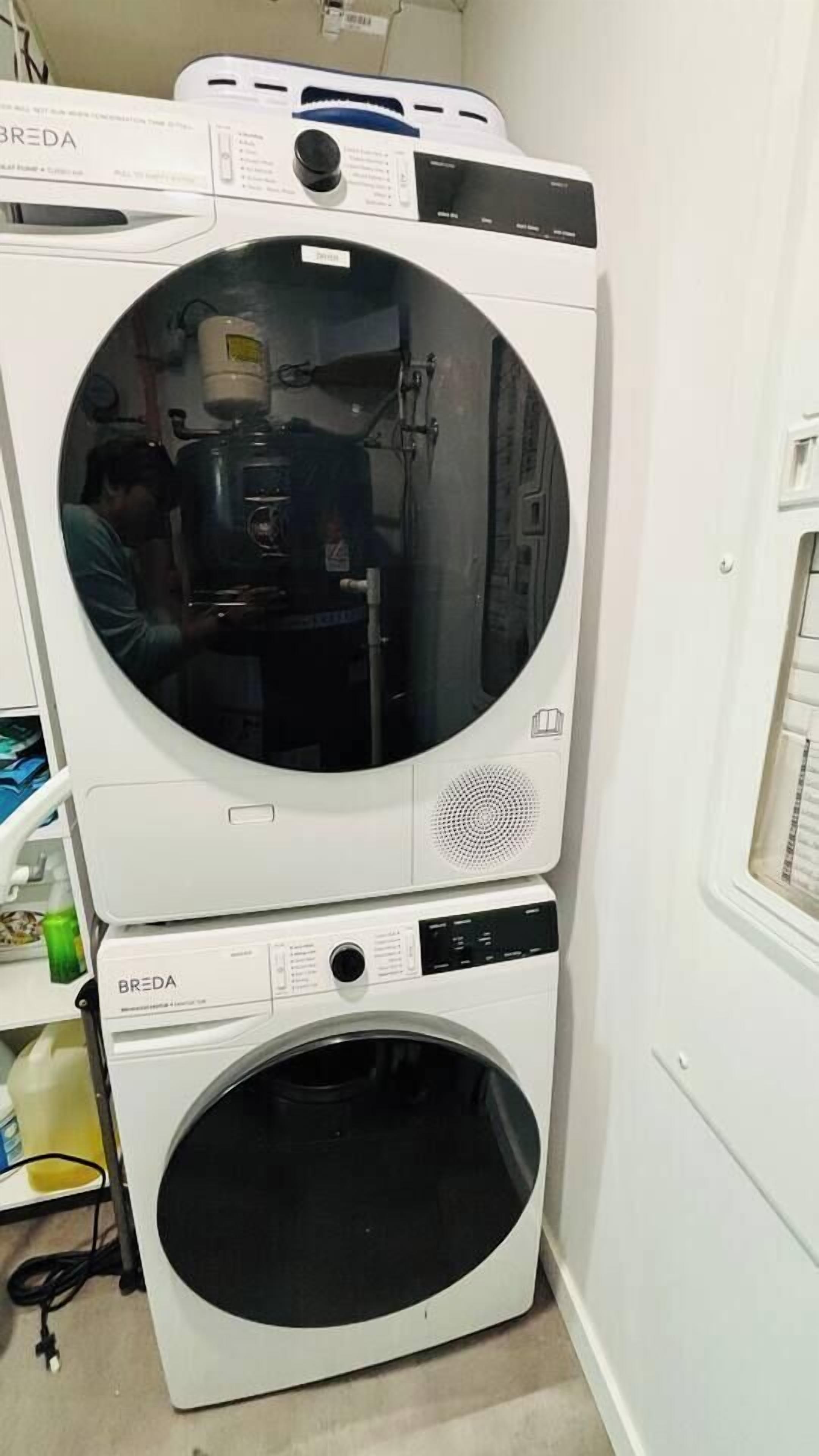 A stacked washer and dryer unit with a control panel and a visible door handle.