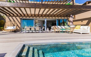 A poolside area with a covered seating area, a dining setup, and a view of the interior. - Amazing home in San Bartolome de Tiraj (San Bartolome de Tiraj)