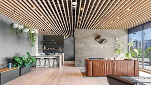 A modern interior with a kitchen, seating area, and large windows. - Two Hyve Homes, One Epic Nashville Stay (Nashville)