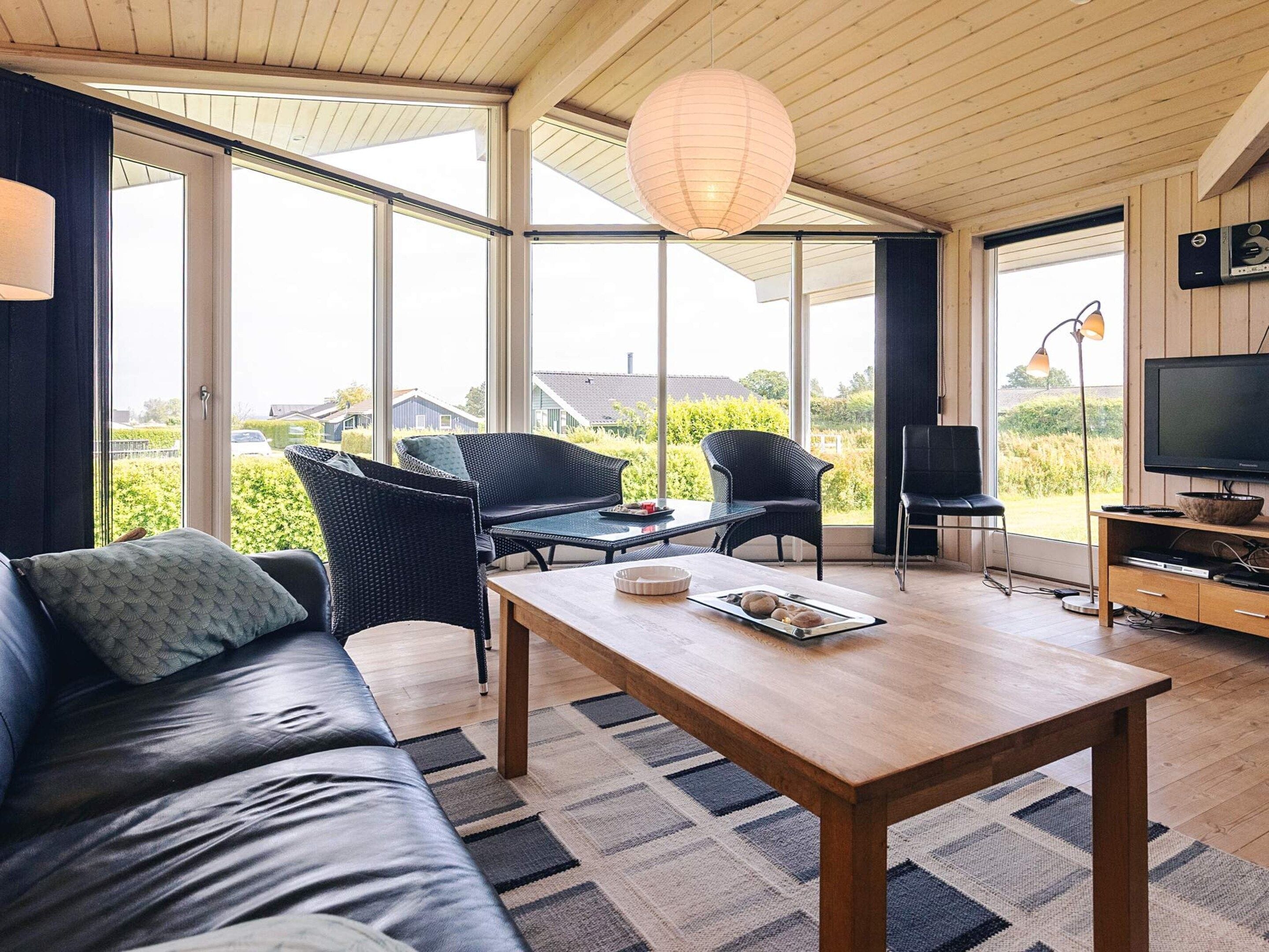 A modern living room with a sofa, a coffee table, and a television.