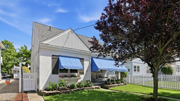 A single-story house with a covered porch and a well-maintained lawn. - Charming Single-Family Beach Retreat in the Heart of Ocean City (Ocean City)