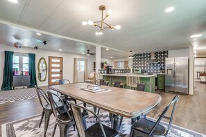 A spacious kitchen with modern appliances, a dining area with a wooden table and chairs, and a ceiling with recessed lighting. - Lakeside Granbury Home w/ Huge Backyard and Dock (Granbury)
