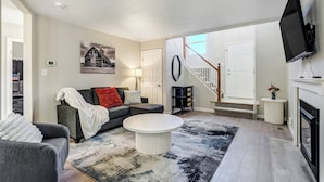 Ein Wohnzimmer mit einer Couch, einem Couchtisch und einem Kamin.