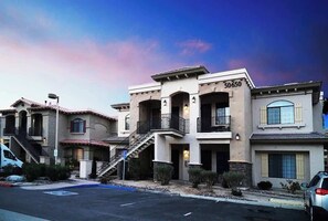 A multi-story residential building with a beige facade, balconies, and a visible address number. - La Quinta Desert Escape · Pools, Golf, Old Town (La Quinta)