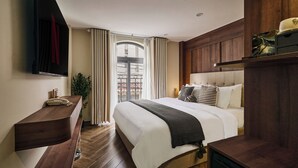 A hotel room with a bed, bedside table, TV, and a view of the outside. - Centoria Hotel Quang Trung by Urban B (Ho Chi Minh City)