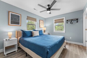 A bedroom with a bed, nightstands, a ceiling fan, and a window with blinds. - Steps to Port of Kimberling & Table Rock Lake_Free Attraction Tickets (Kimberling City)
