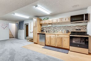 A modern kitchen with wooden cabinets, a built-in microwave, and a stainless steel oven. - BOULDER SUNSET ❤️ (Boulder)