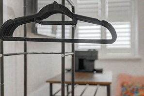 A black hanger on a metal rack. - GuestReady - Chic City Studio in Vibrant Liverpool (Liverpool)