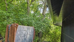 A hot tub with a wooden deck and a mattress on top.