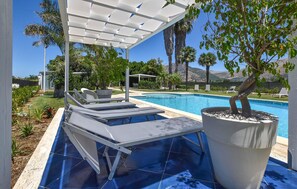 A poolside area with lounge chairs, a pergola, and a potted tree. - Nice home in Partinico (Partinico)