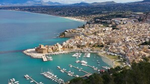 A coastal cityscape with a marina, historic buildings, and a mountainous backdrop. - Nice home in Partinico (Partinico)