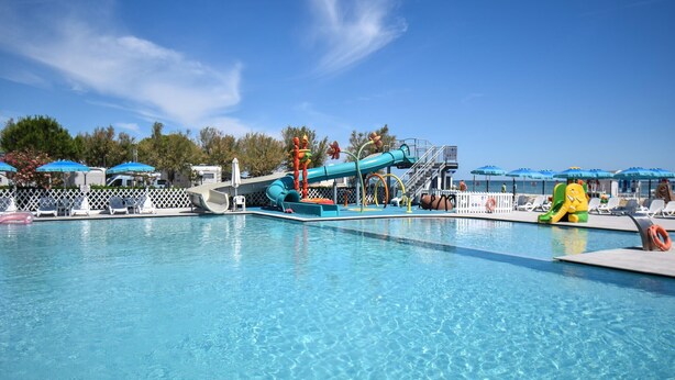A swimming pool with a water slide, lounge chairs, and umbrellas. - Pet friendly home in Torino di Sangro with WiFi (Torino di Sangro)