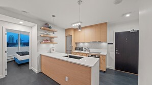 Una cocina moderna con una isla central, electrodomésticos integrados y vistas a la ciudad.