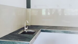 A kitchen with a sink, a faucet, and a countertop. - Habarana Guest House  (Habarana)