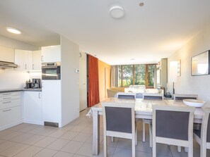 A modern kitchen with white cabinets, a built-in oven, and a coffee machine. - Holiday home with 3 bedrooms near the sea (Westende)