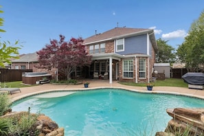 A two-story house with a backyard swimming pool, a covered patio, and a barbecue area. - MoxieStays / Pool, Spa, Billiards Room and Theater (Frisco)