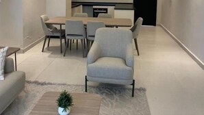 A modern interior with a dining area, a sofa, and a coffee table.