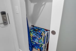A bathroom with a white door, a towel rack with a blue towel, and a shower curtain. - Stylish Designer Resort Studio Vistas (Kihei)