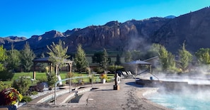 A hot spring area with a pool, lounge chairs, and a gazebo. - Iconic Yellowstone National Park Getaway for Serene and Peaceful Nature Trips (Gardiner)