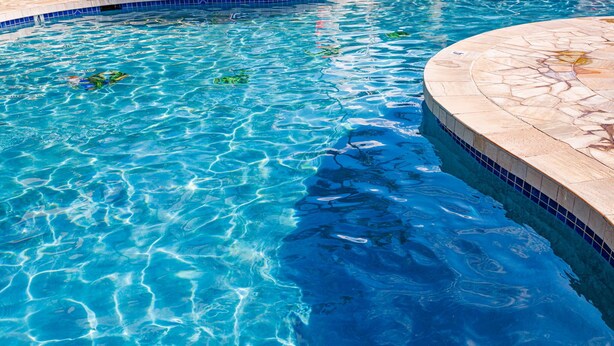 A clear blue pool with a tiled edge and a stone deck surrounding it. - 2 2 New Designer Beachside Resort Vistas (Kihei)