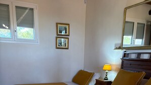 A hotel room with two beds, each with a brown bedspread and white towels. There is a nightstand with a lamp, a dresser, and two framed pictures on the wall. - The tranquility of the countryside, just a stone's throw from the sea and the Selinunte Archaeological Park (Sicilia)